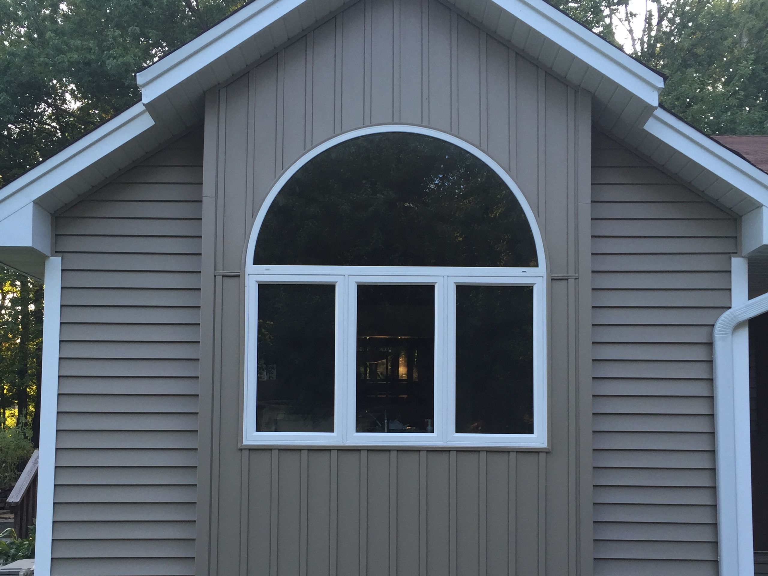 Arched window and new Siding in a gable end