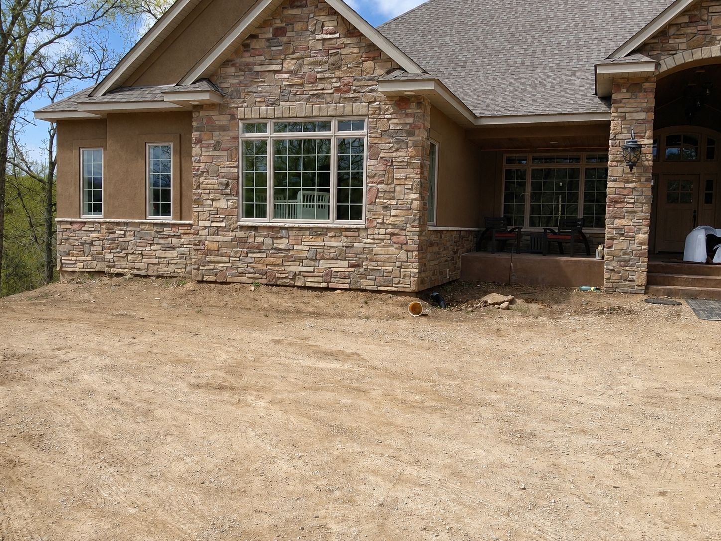 Stone and stucco Craftsman ranch with new grid Windows