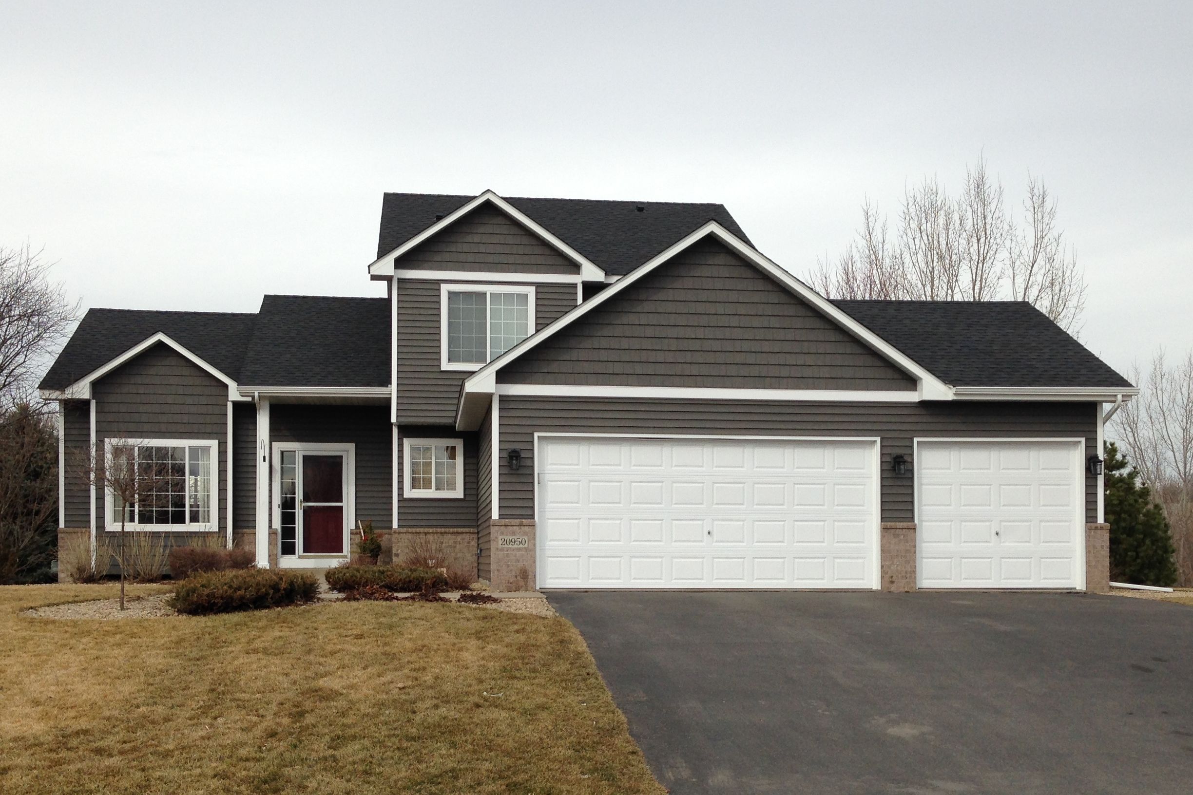 Two-story home finished in dark gray lap Siding with white trim