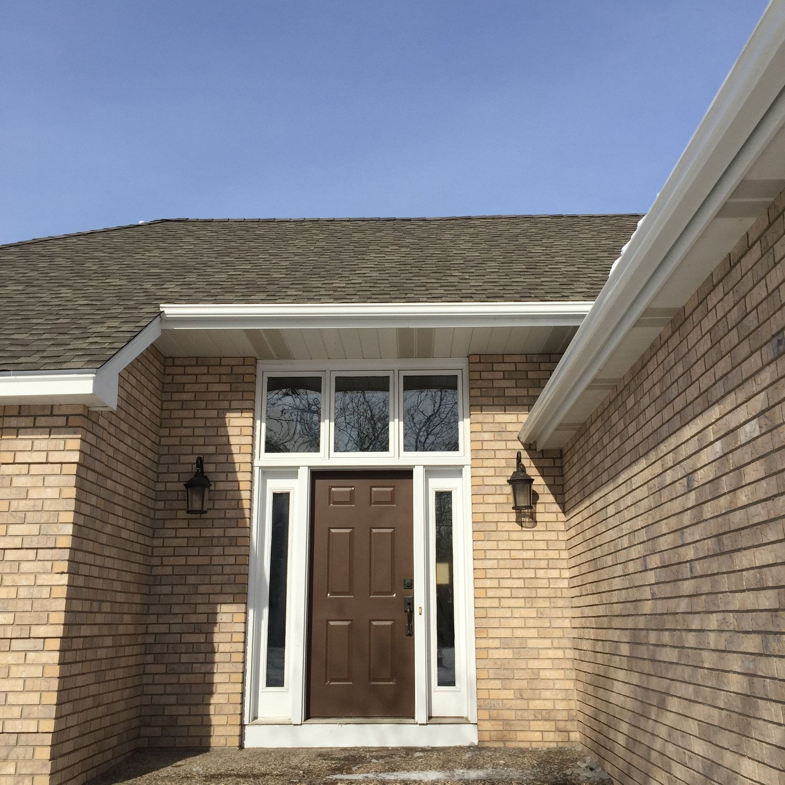 Sidelights and transom around a brick entry door