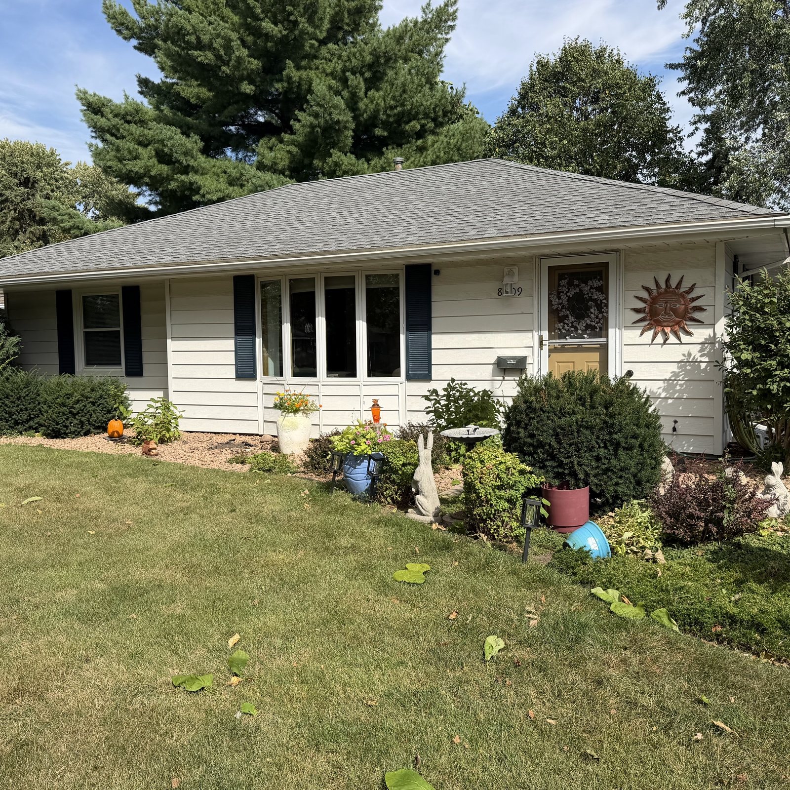 Front garden and shuttered Windows on a cream rambler