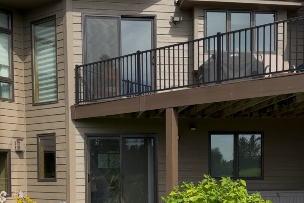 Tan lap Siding on the rear of a home with a balcony