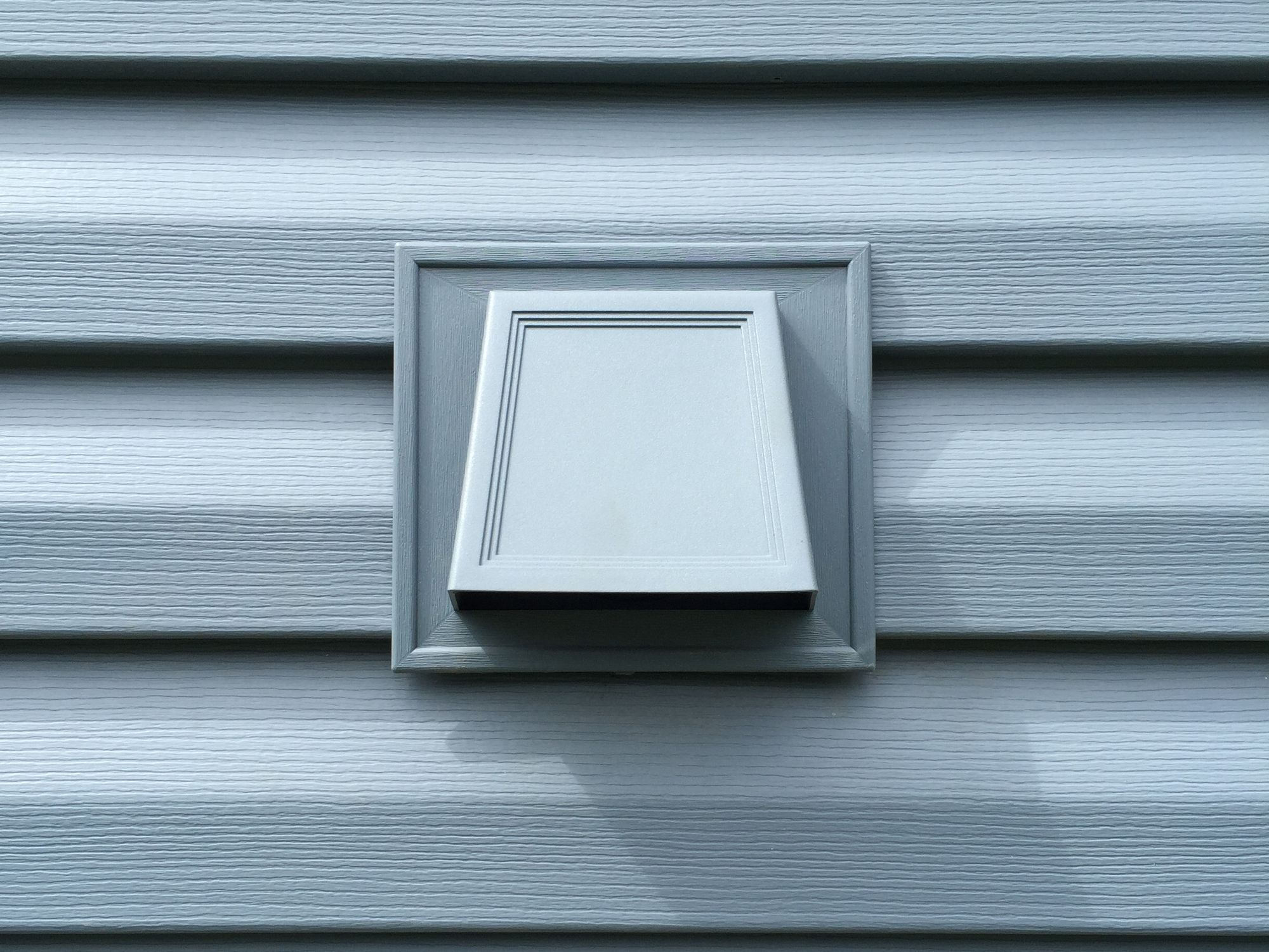 Exhaust vent trimmed into new lap Siding