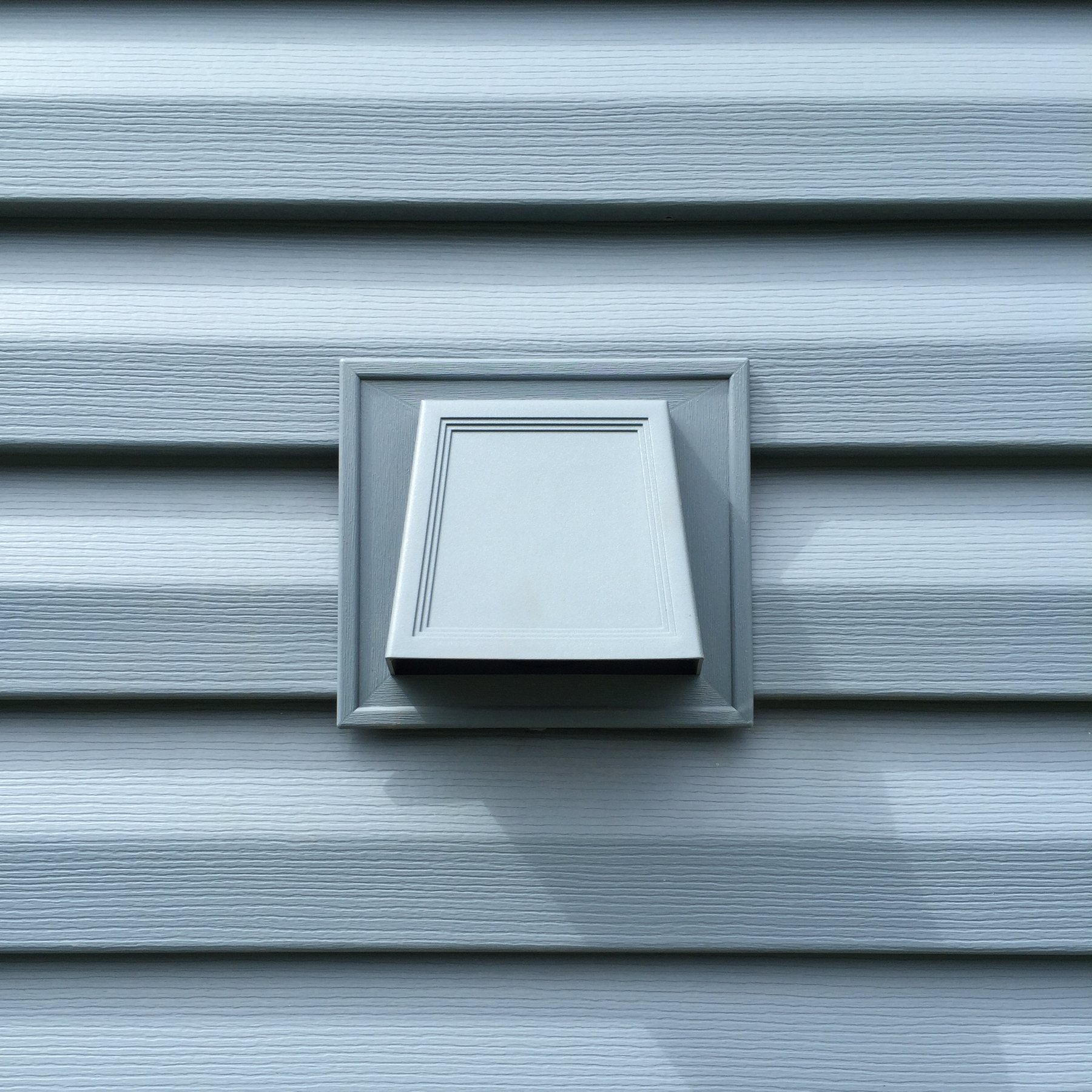 Wall vent centered in new vinyl lap Siding